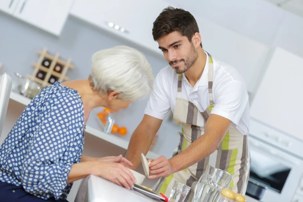 A personal chef showing his client her meal.