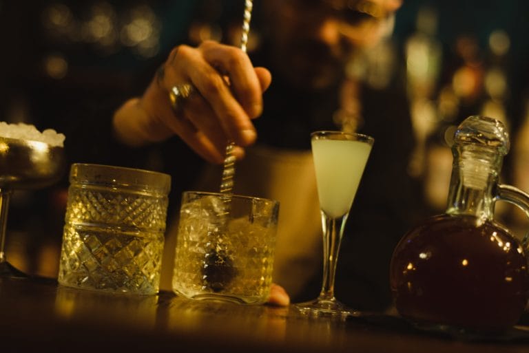 A bartender stirs a drink.