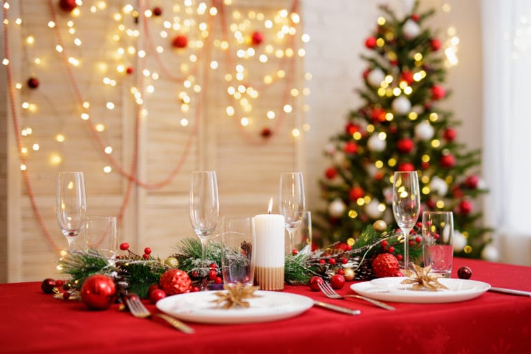 Decorated table with plates and glasses for christmas dinner