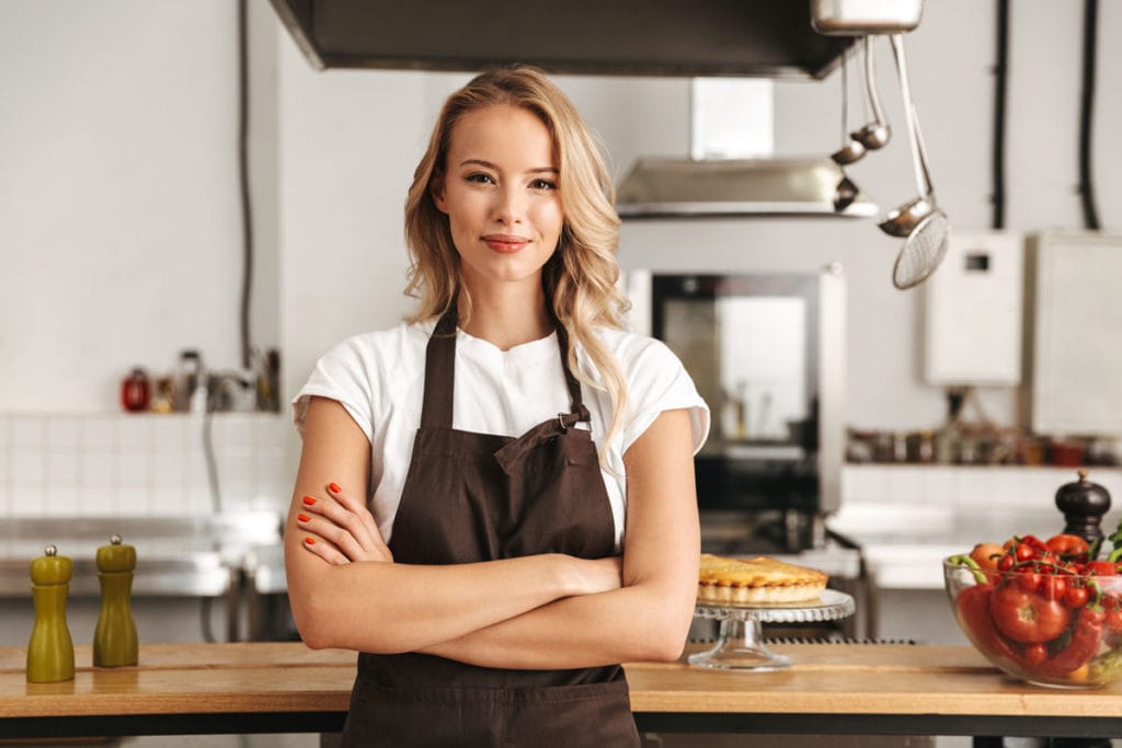 Chef standing proudly in commercial kitchen