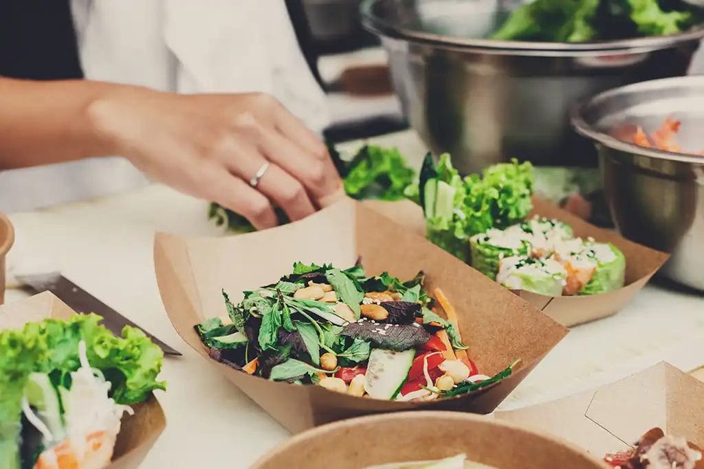 Trays of salad being prepared