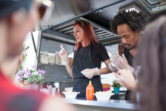 Food truck workers wearing gloves