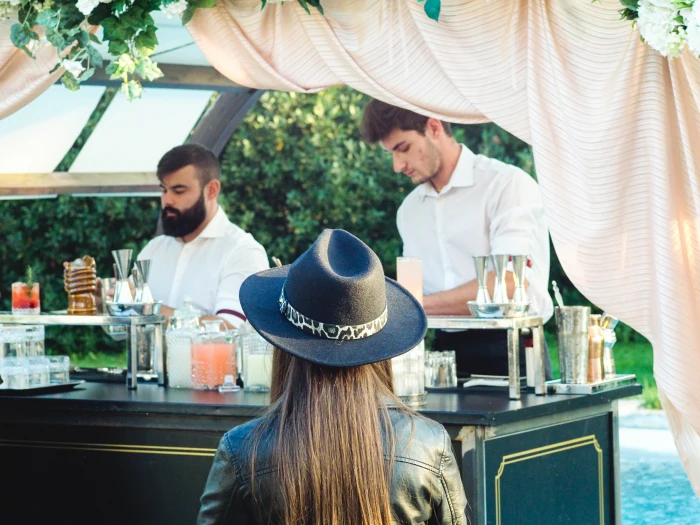 Two freelance bartenders serving a cocktail party.