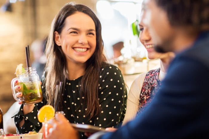 A woman drinking mocktails with friends.