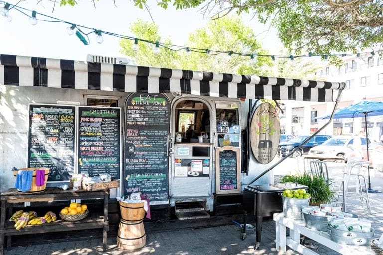 A food trailer serving healthy vegan food on a sunny day in Florida.