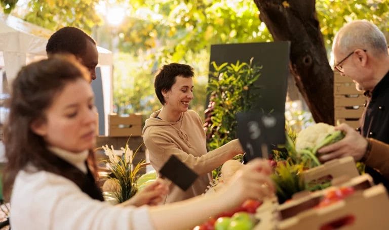 Young happy cheerful woman enjoying shopping experience at local farm market.