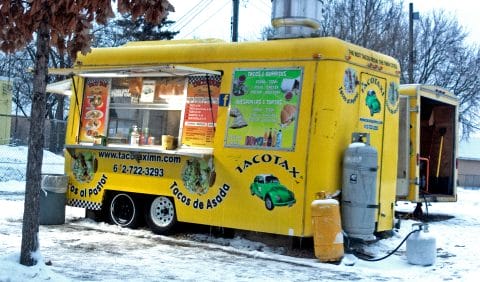 Yellow food truck in the snow.