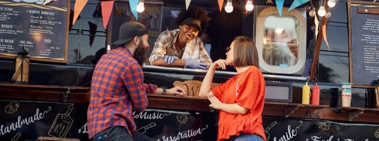 North Carolina food truck employee serving a couple.